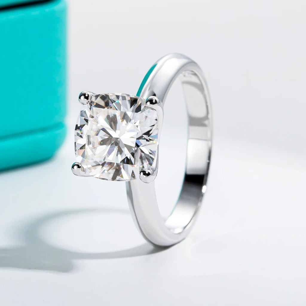 Silver ring with a large diamond on a light gray background