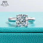 Diamond ring on a textured blue surface with 'Anu Jewel' branding.